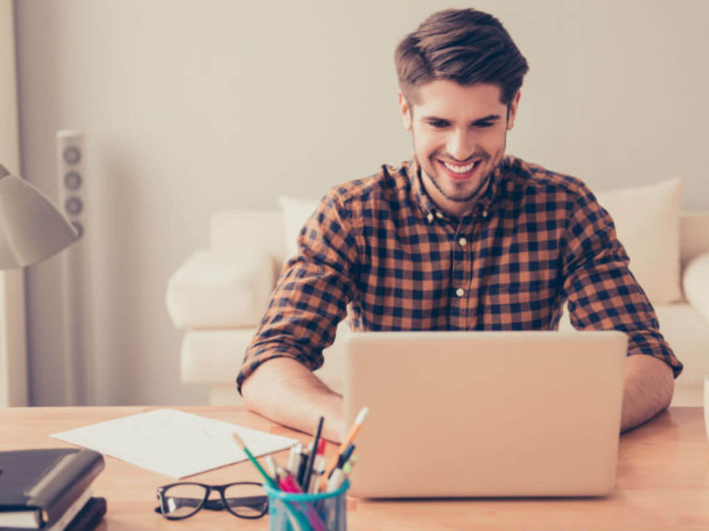 man infront of a laptop