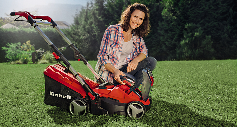 Lawn mower and woman in the garden