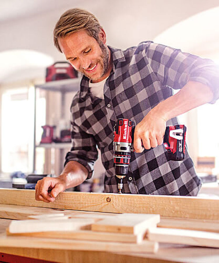 man using a cordless screwdriver 